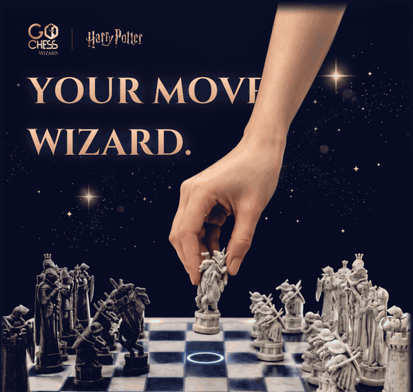 Your move, wizard. A hand sets the white knight down on the GoChess Wizard board while a blue light marks its square.