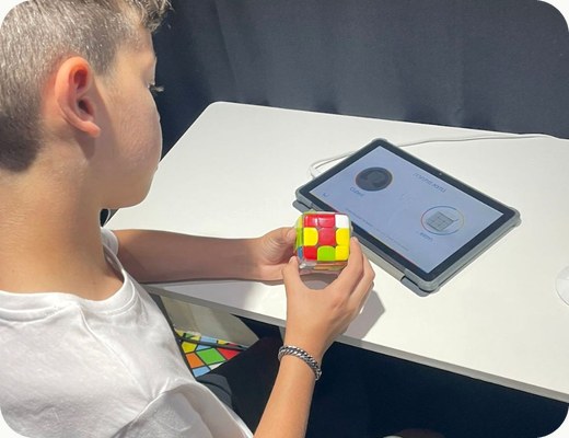 A boy playing a GoCube game on a tablet